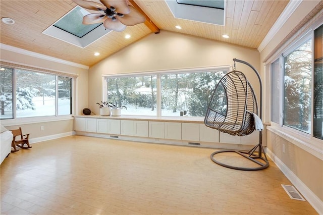 sunroom / solarium featuring a wealth of natural light, ceiling fan, and wood ceiling