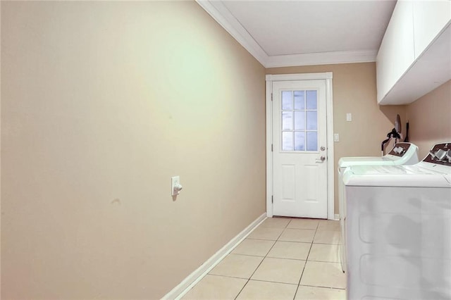 laundry area with washer and clothes dryer, light tile patterned flooring, cabinets, and crown molding