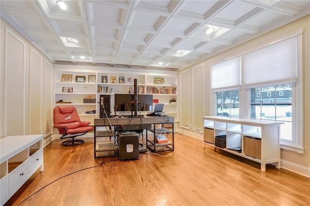 office area featuring built in shelves, light hardwood / wood-style floors, and coffered ceiling