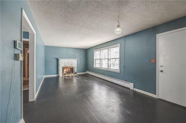 unfurnished living room featuring baseboard heating and a textured ceiling