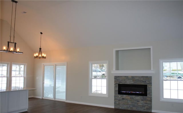 unfurnished living room featuring dark wood-type flooring, a wealth of natural light, and high vaulted ceiling