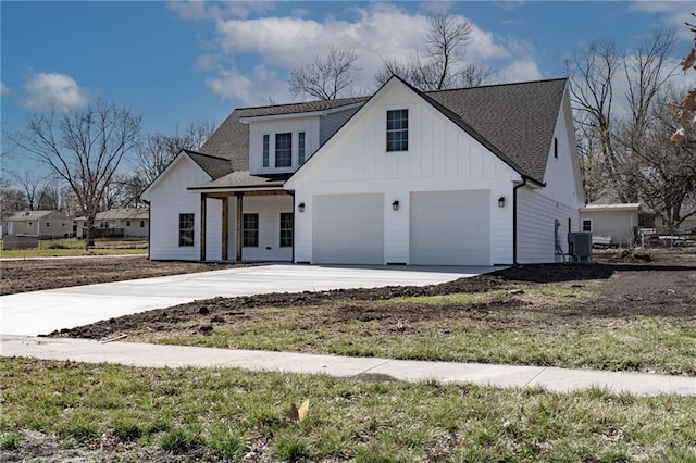 modern inspired farmhouse with board and batten siding, central air condition unit, concrete driveway, roof with shingles, and a garage