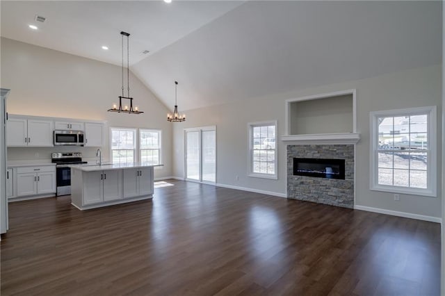 kitchen featuring plenty of natural light, appliances with stainless steel finishes, open floor plan, and light countertops