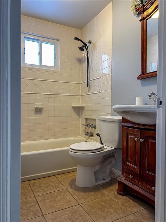 full bathroom featuring tile patterned floors, vanity, toilet, and tiled shower / bath combo