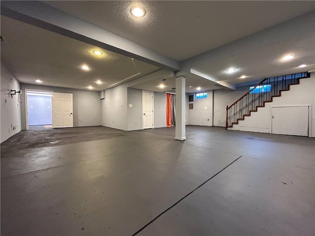 basement featuring a textured ceiling