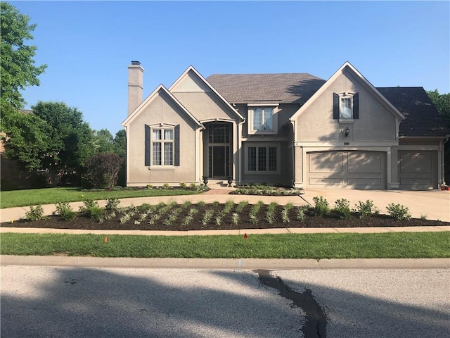 view of front of home featuring a garage and a front lawn