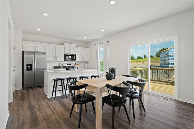 dining area featuring dark wood-style floors, recessed lighting, and baseboards