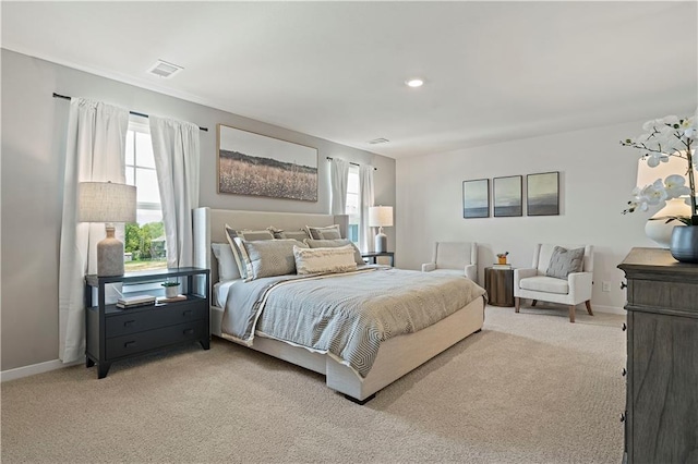 bedroom with light colored carpet, baseboards, and multiple windows