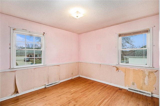 spare room with wood-type flooring and wooden walls