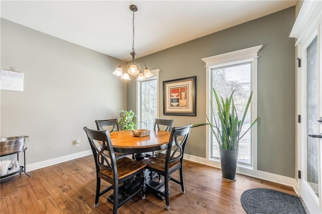 dining space with a chandelier, hardwood / wood-style flooring, and a healthy amount of sunlight