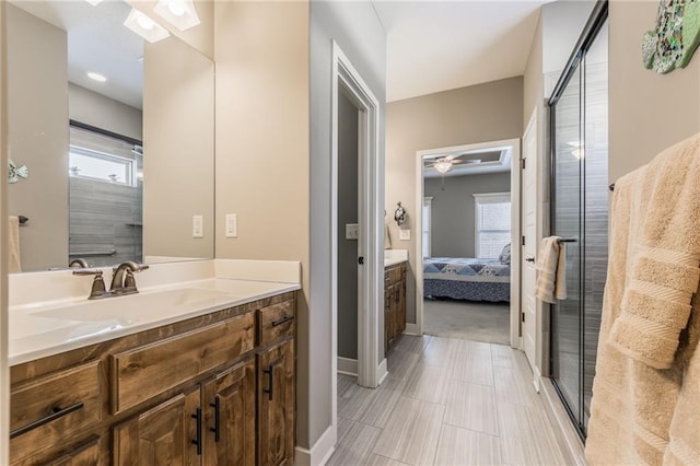 bathroom with ceiling fan, vanity, and an enclosed shower