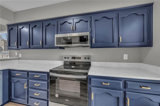 kitchen with stainless steel appliances and blue cabinets