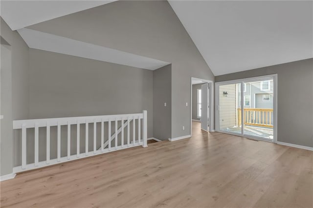 interior space with light hardwood / wood-style floors and high vaulted ceiling