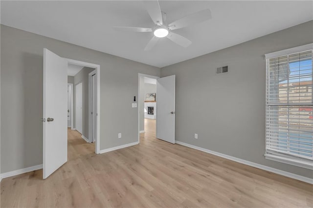 unfurnished bedroom featuring ceiling fan and light hardwood / wood-style floors