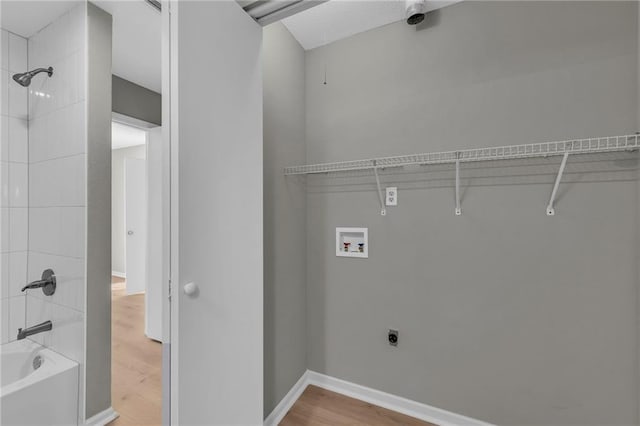 washroom featuring hardwood / wood-style floors, washer hookup, and hookup for an electric dryer