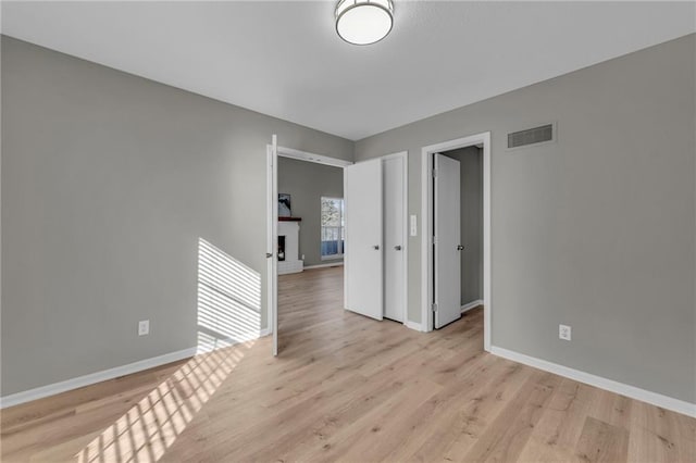 spare room with light wood-type flooring