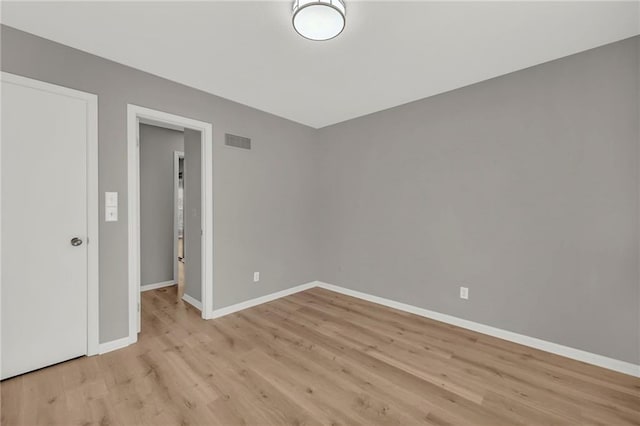 spare room featuring light hardwood / wood-style flooring