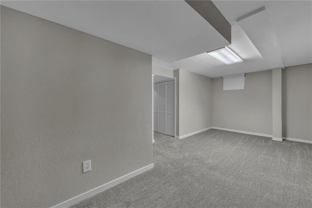 basement featuring light carpet