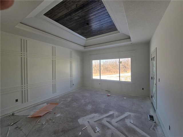 unfurnished bedroom with a tray ceiling