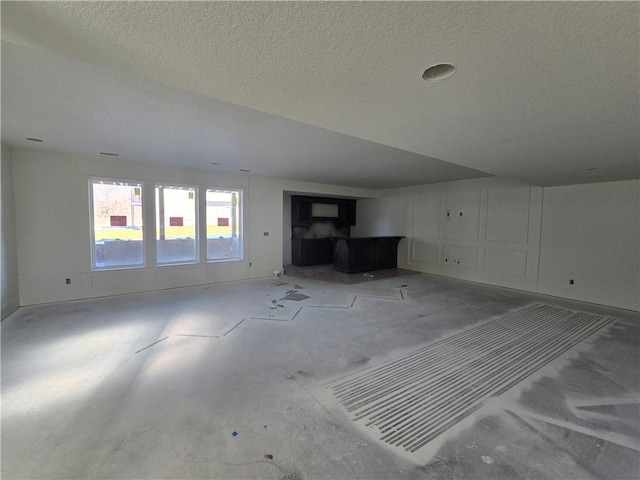 unfurnished living room with a textured ceiling