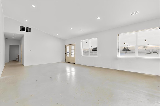 spare room with lofted ceiling and french doors