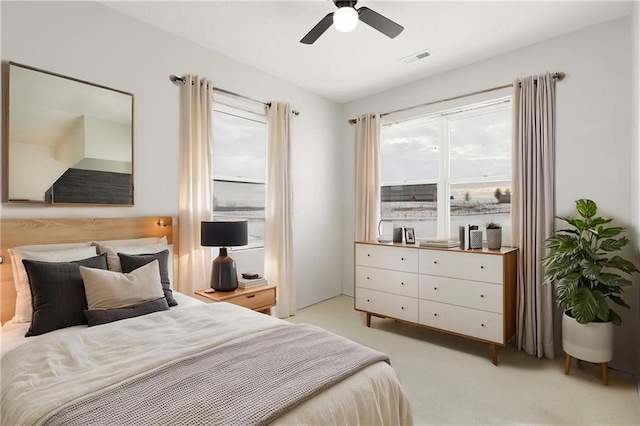bedroom featuring light colored carpet and ceiling fan