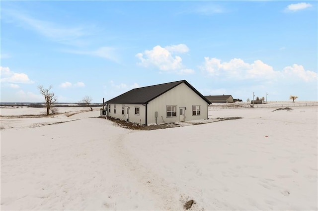 view of snow covered rear of property
