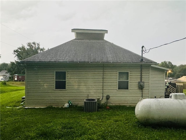 view of home's exterior with a yard and cooling unit