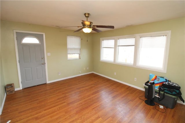 entrance foyer with light wood-style floors, ceiling fan, and baseboards