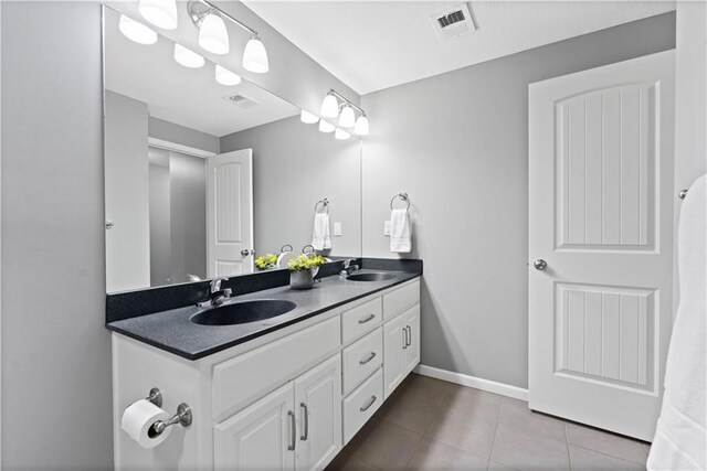 bathroom with tile patterned flooring and vanity