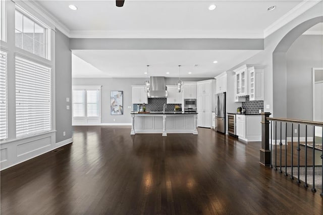 living room with wine cooler, ornamental molding, dark hardwood / wood-style floors, and sink