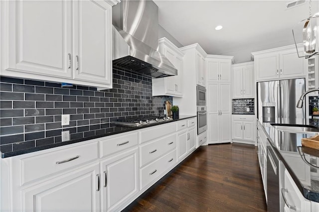 kitchen featuring wall chimney range hood, sink, white cabinetry, stainless steel appliances, and dark hardwood / wood-style floors