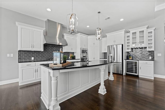 kitchen with white cabinetry, appliances with stainless steel finishes, wall chimney range hood, and wine cooler