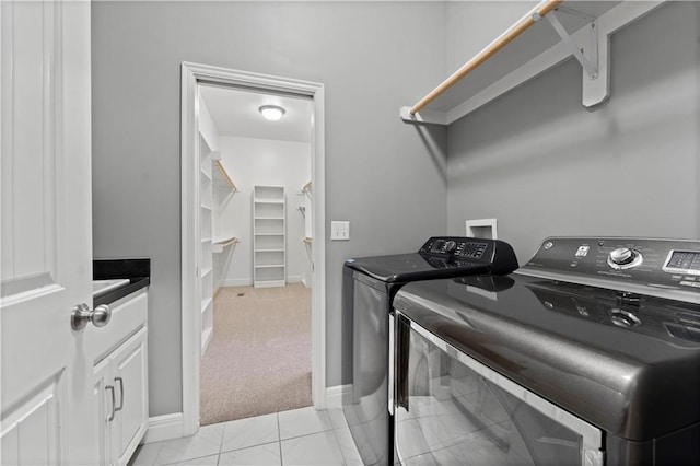 clothes washing area with cabinets, independent washer and dryer, and light carpet