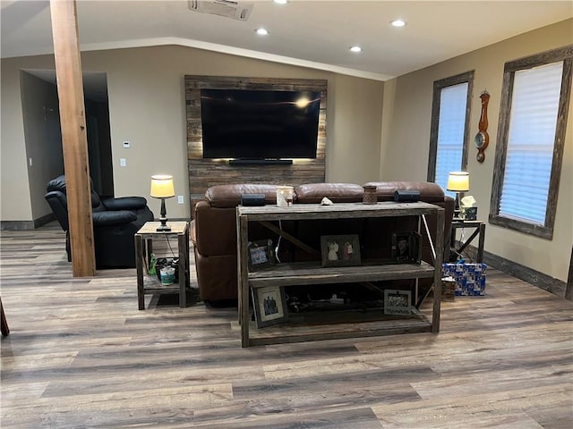 living room featuring hardwood / wood-style flooring and lofted ceiling