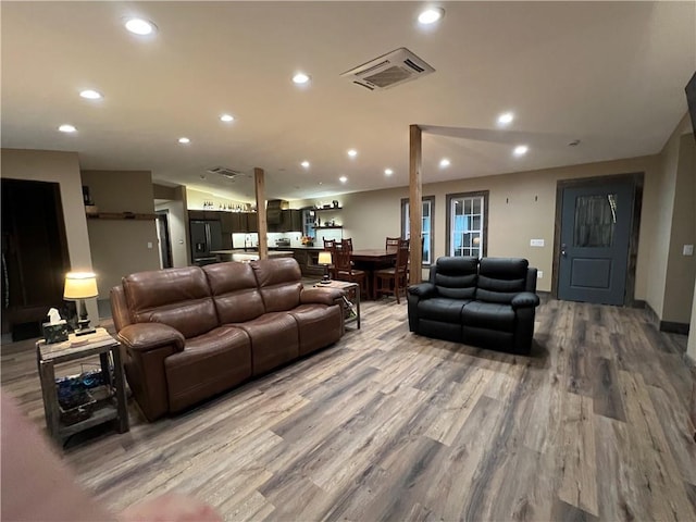 living room featuring hardwood / wood-style floors and lofted ceiling