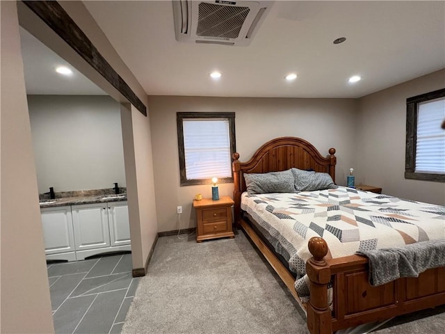 carpeted bedroom with sink