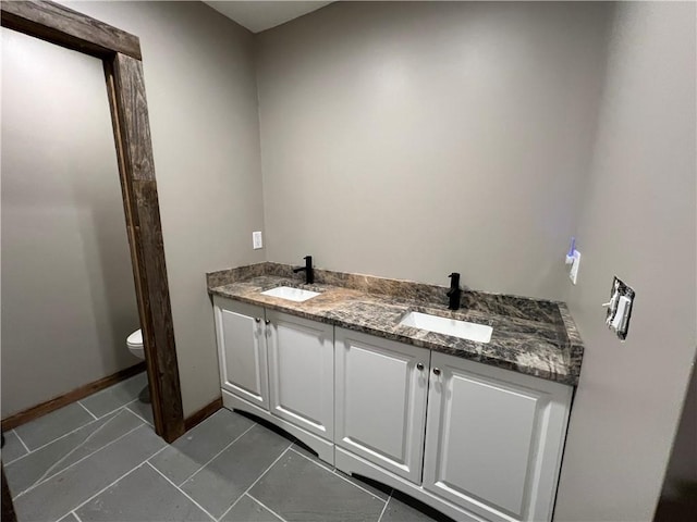 bathroom with tile patterned flooring, vanity, and toilet