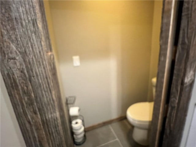 bathroom with tile patterned flooring and toilet