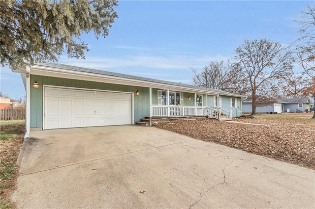 ranch-style home with a garage and covered porch