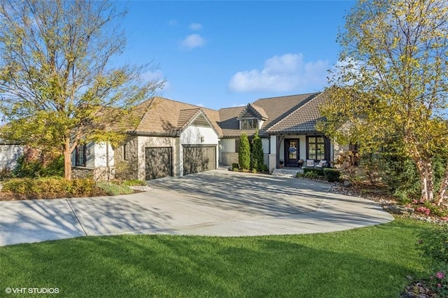 tudor-style house with a garage and a front lawn