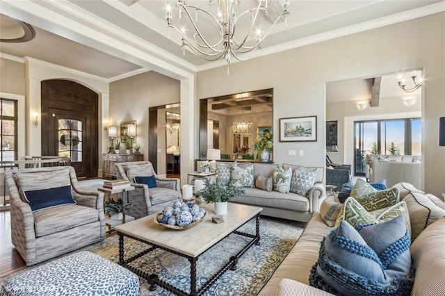 living room featuring ornamental molding and a notable chandelier