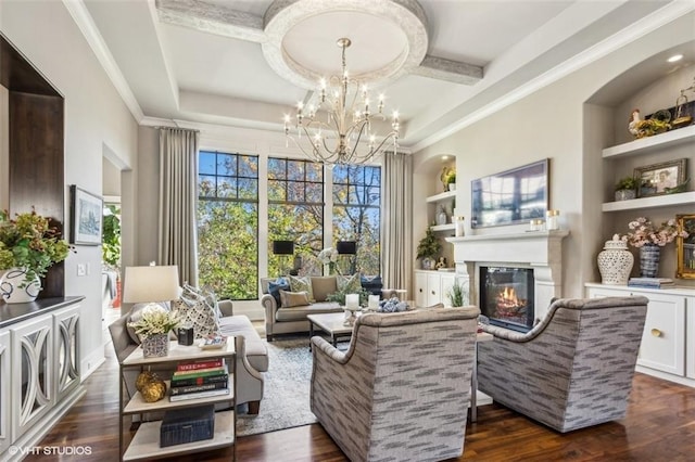 living area featuring a notable chandelier, ornamental molding, built in features, and dark hardwood / wood-style floors