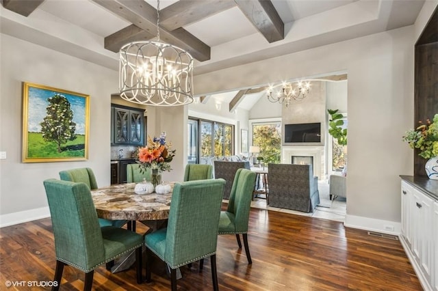 dining room featuring beamed ceiling, dark wood-type flooring, and a chandelier