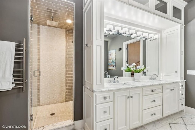 bathroom featuring vanity and a shower with shower door