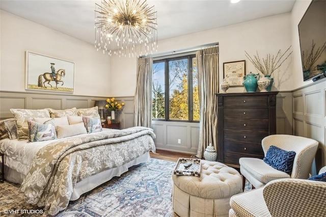 bedroom with hardwood / wood-style flooring and a notable chandelier