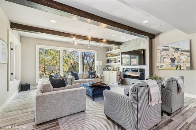 living room with a fireplace, light hardwood / wood-style floors, and beam ceiling