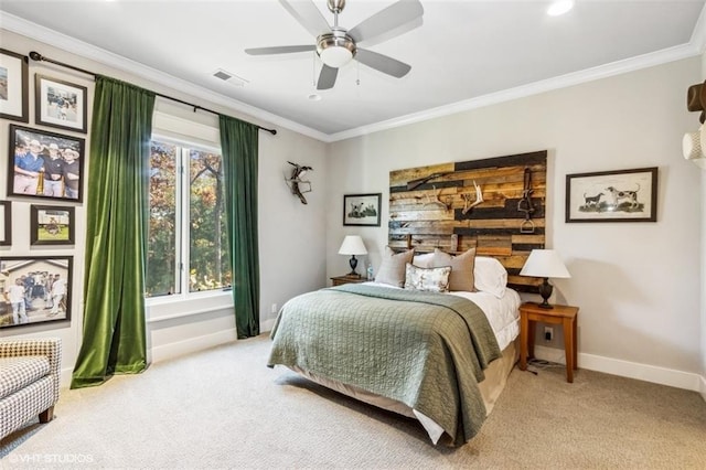 carpeted bedroom with ornamental molding and ceiling fan