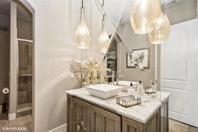 bathroom with vanity and a shower with shower door