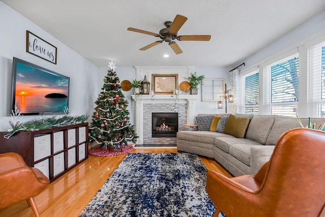 living room with hardwood / wood-style floors and ceiling fan